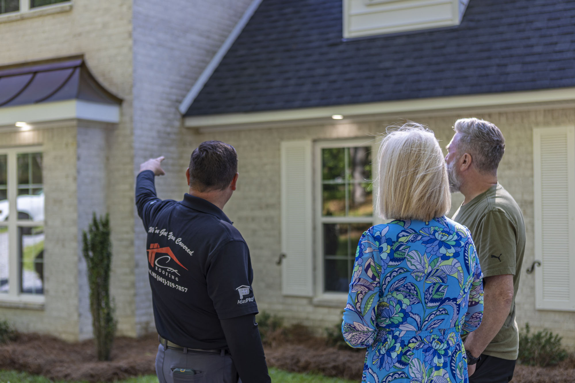 residential roofing contractor consults with a homeowner