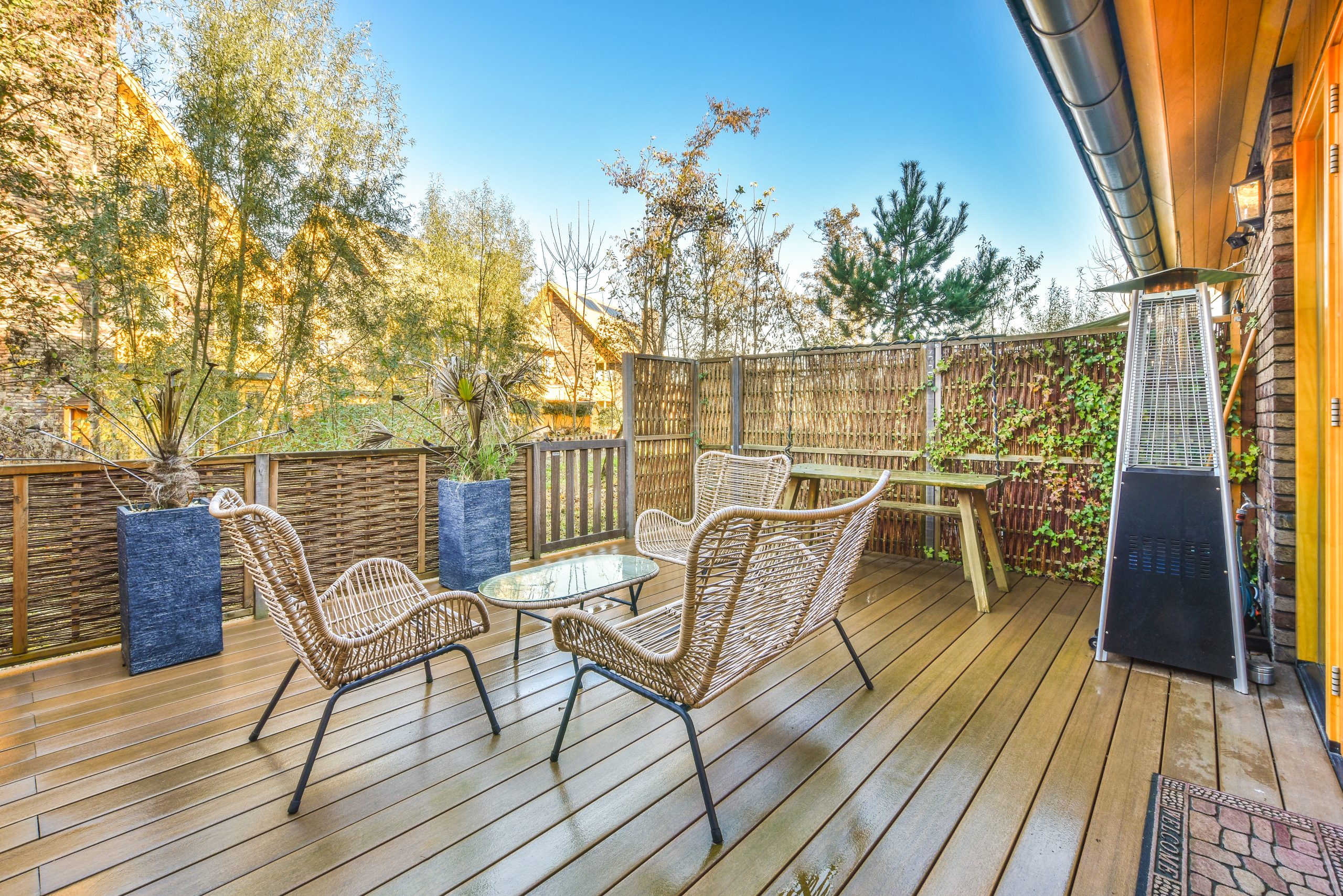 a photo of a wooden deck with table and chairs