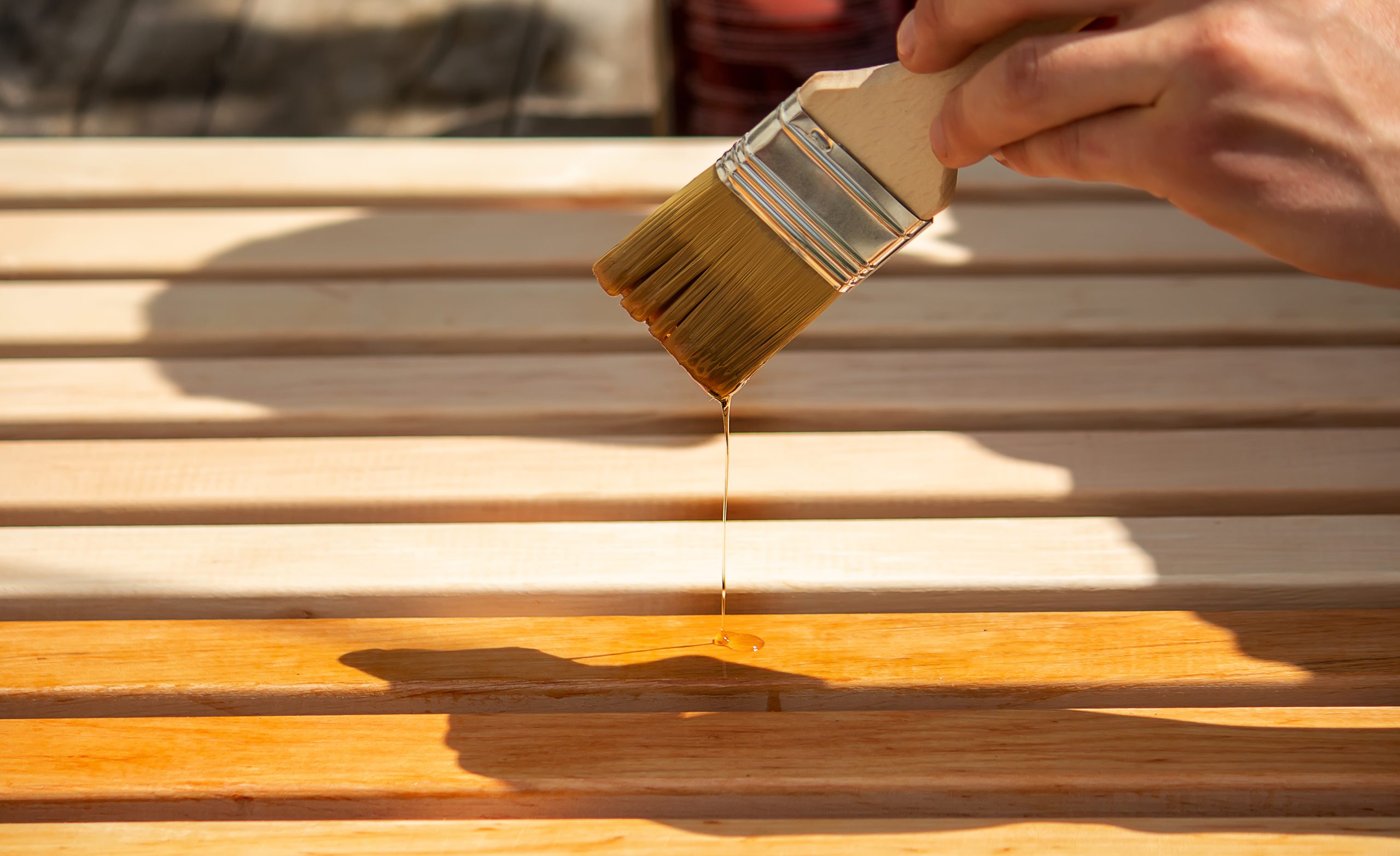 Painting wooden furniture with varnish.